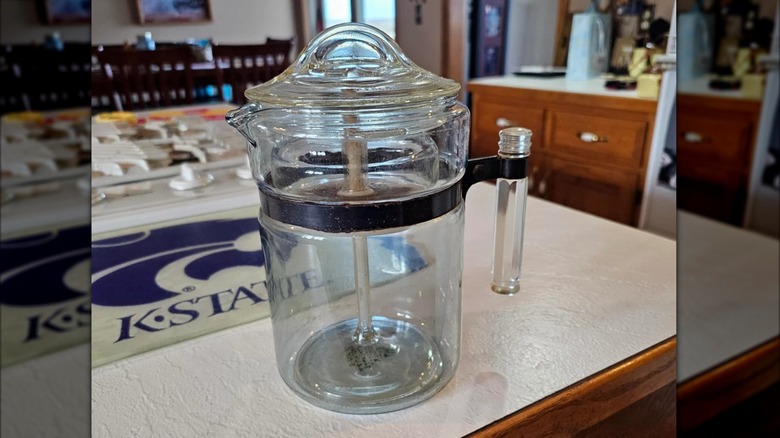 A vintage Pyrex percolator sitting on a countertop