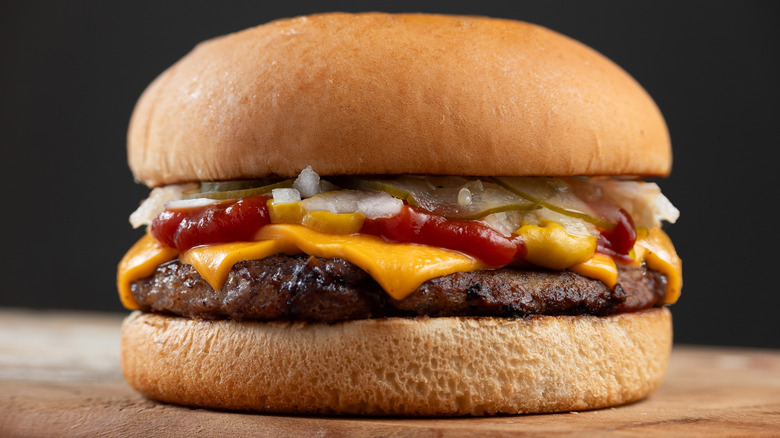 Quarter Pounder with cheese on a wooden table against a dark background