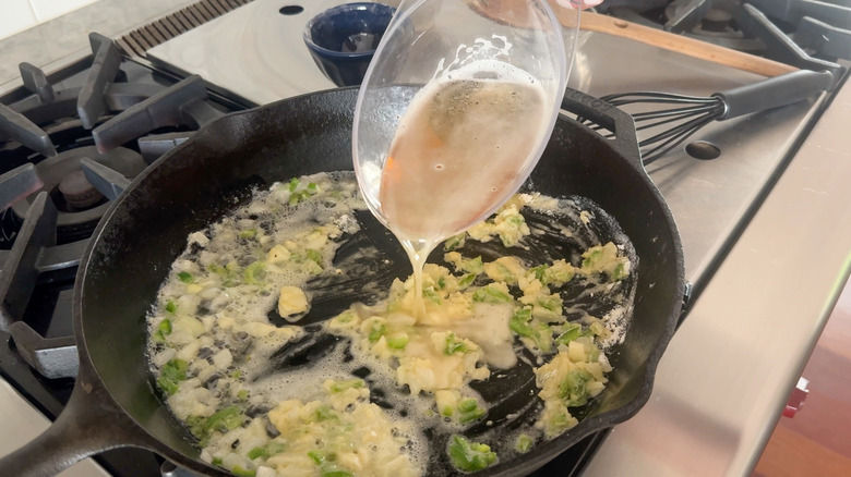 adding beer to skillet