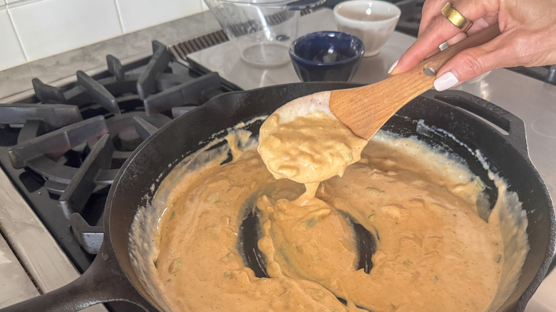 hand holding spoon with sauce