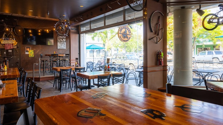 Bike-themed interior of Taphouse Unchained with wooden tables