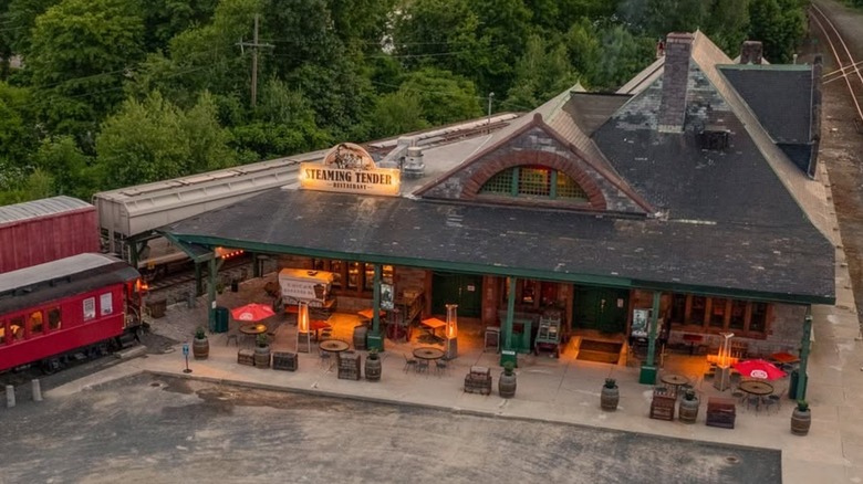 Exterior aerial view of Steaming Tender restaurant next to train cars