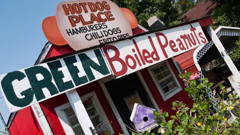 Exterior of The Tomato Place with signs for hot dogs and peanuts