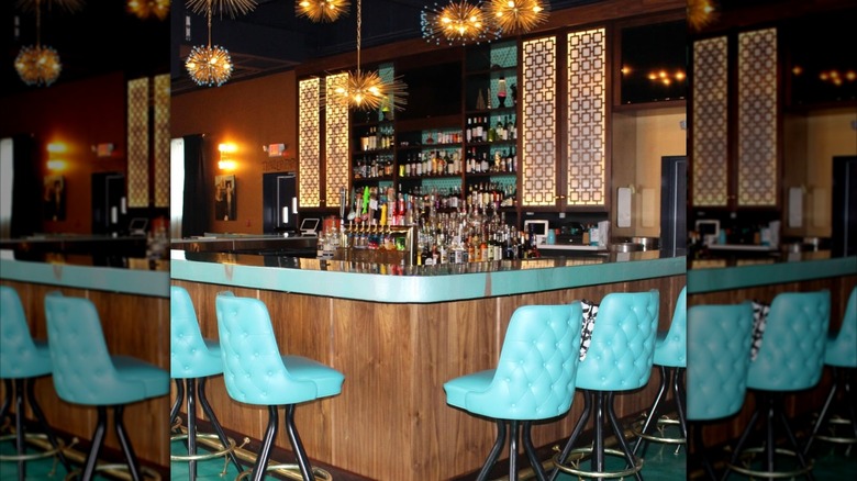 Vintage retro bar with blue bar chairs and funky hanging lights