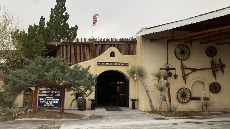 Exterior and entrance of Cattleman's with farm equipment hanging on the walls