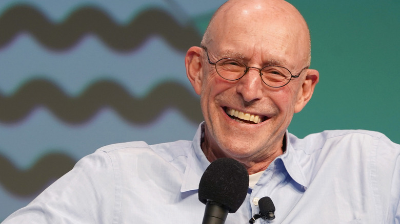 Author Michael Pollan holding a microphone and speaking at the 2019 SXSW Conference and Festivals