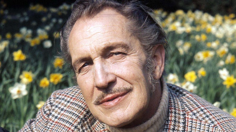 Vincent Price before a field of flowers