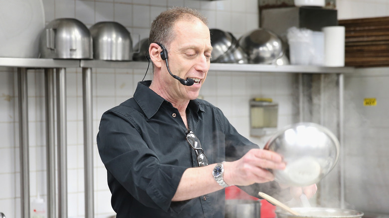 David Lebovitz cooking at an even with a microphone attached to his ear