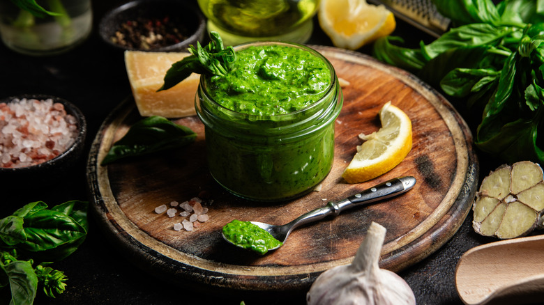 small jar of pesto sauce surrounded by ingredients