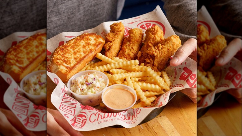 a basket of chicken tenders, fries, coleslaw, sauce, and Texas toast from Raising Cane's
