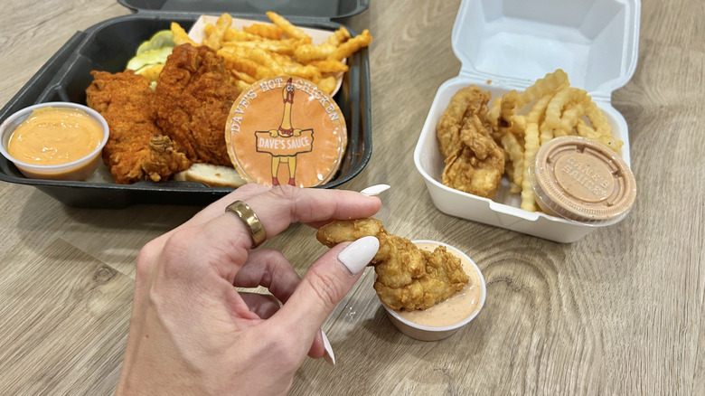 Chicken meals with sauces from Dave's Hot Chicken and Raising Cane's