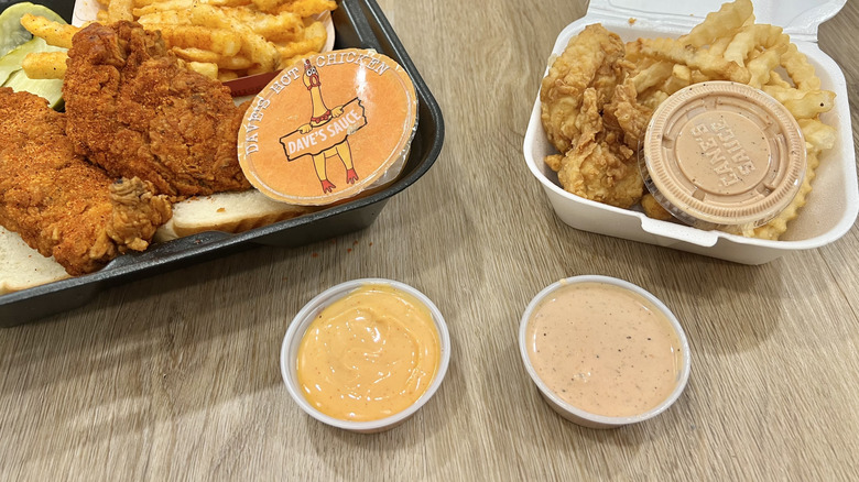 Chicken meals with sauce from Dave's Hot Chicken and Raising Cane's