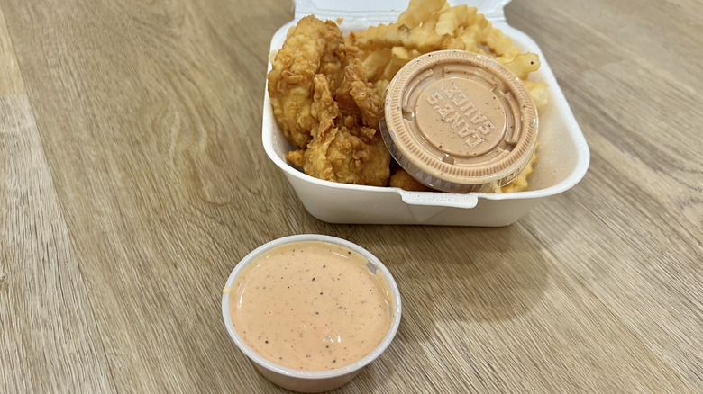 Raising Cane's sauce with chicken fingers meal