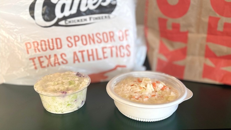 two coleslaws next to takeout packaging
