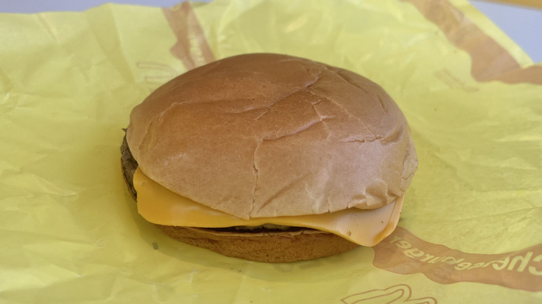 McDonald's Cheeseburger with a yellow paper wrapper