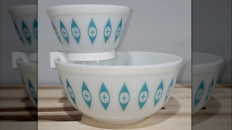 Pyrex Atomic Eyes Chip and Dip bowls on a makeshift stand