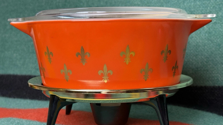 A bright red Pyrex Fleur De Lis Casserole dish