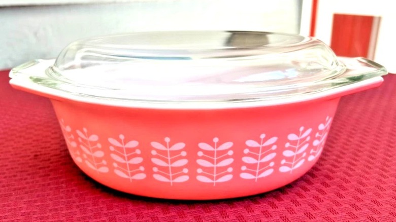 A pink Pyrex casserole dish in the Pink Stems pattern