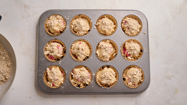 sprinkling streusel over muffins