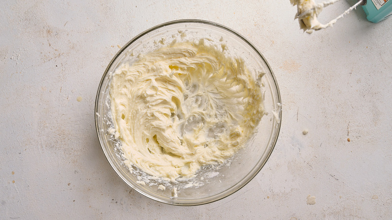 cream cheese and sugar whipped in a bowl