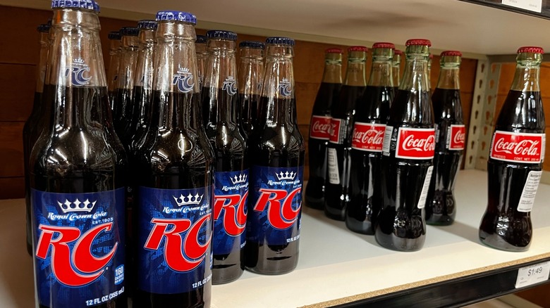 glass bottles of RC Cola and Coca Cola on a shelf