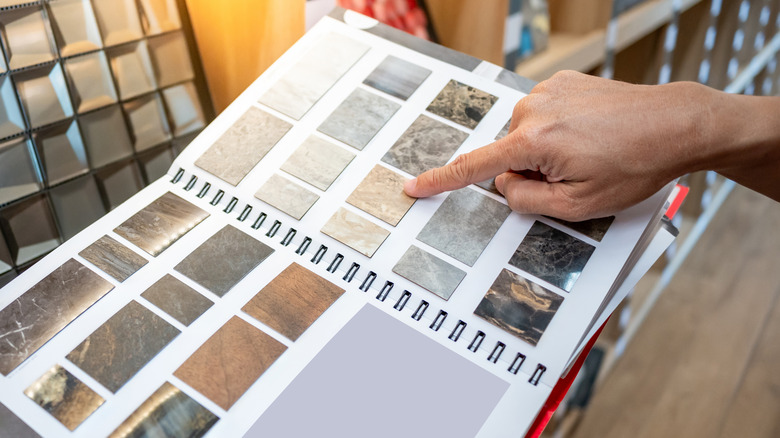 Person selecting countertops in display book