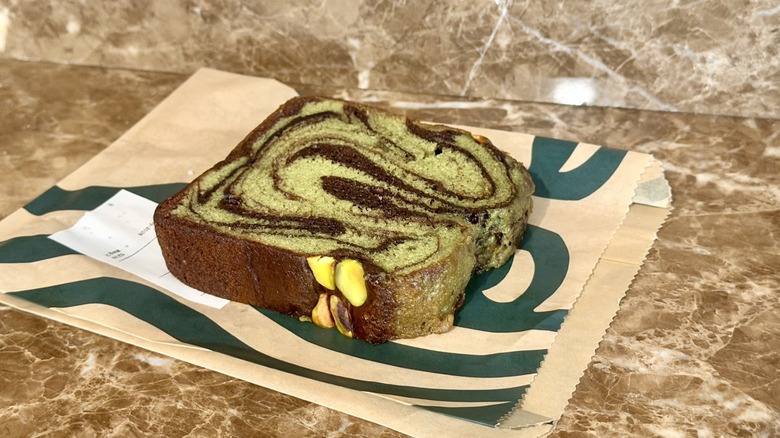 Slice of Starbucks Pistachio Chocolate Loaf on branded paper bag