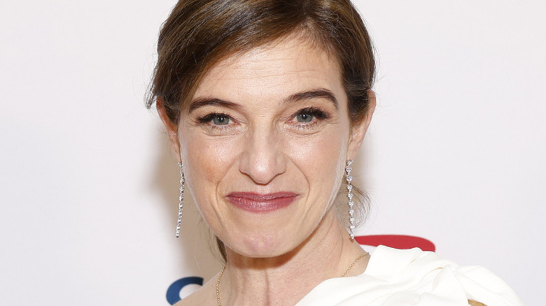 Pati Jinich in a white dress with dangling earrings