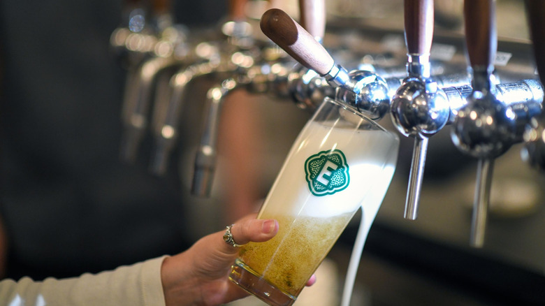 a pint of beer being pulled from a tap