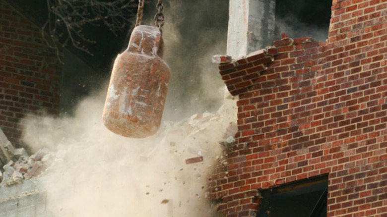A wrecking ball hitting an old building