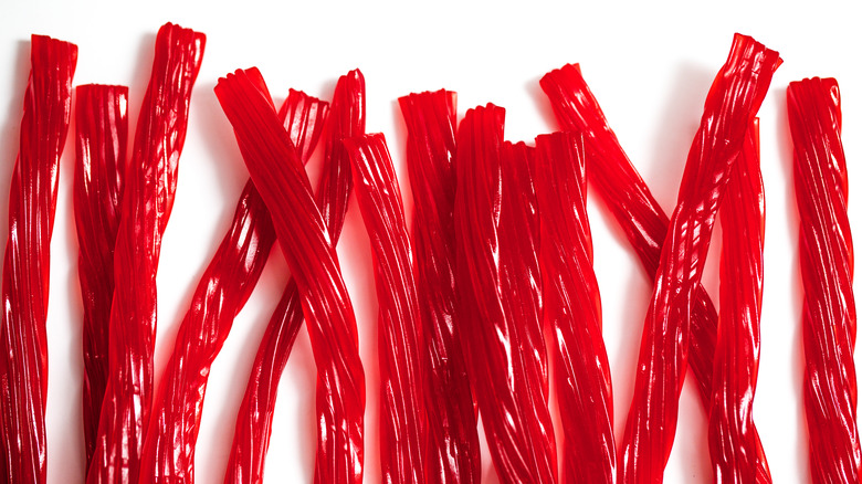 assorted red licorice on white background