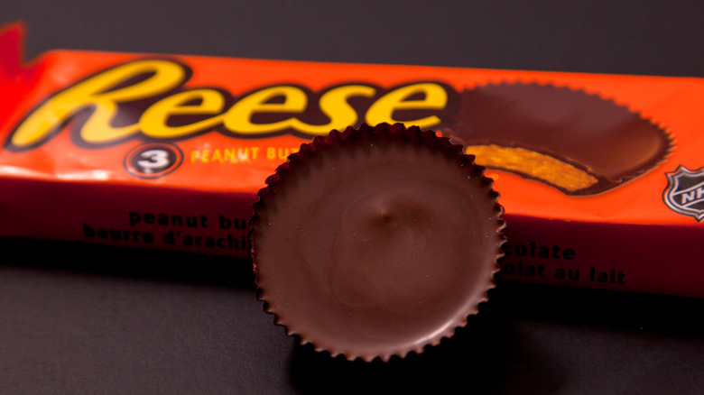 Reese's Peanut Butter Cup package with one open chocolate candy