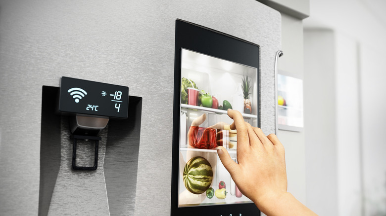 Front of silver smart refrigerator with touchscreen, water maker