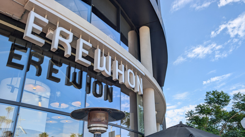 Erewhon grocery store chain exterior with a blue sky on the outside of it