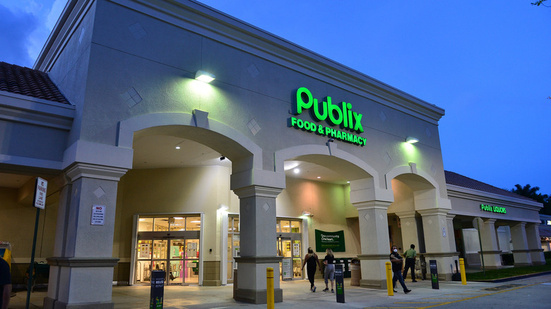 Publix exterior at night with the glowing logo on the front