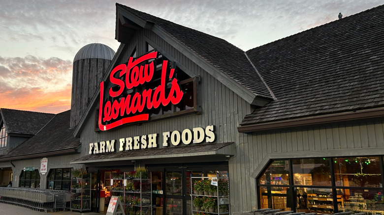Stew Leonard's regional grocery store chain exterior with a sunset sky behind it