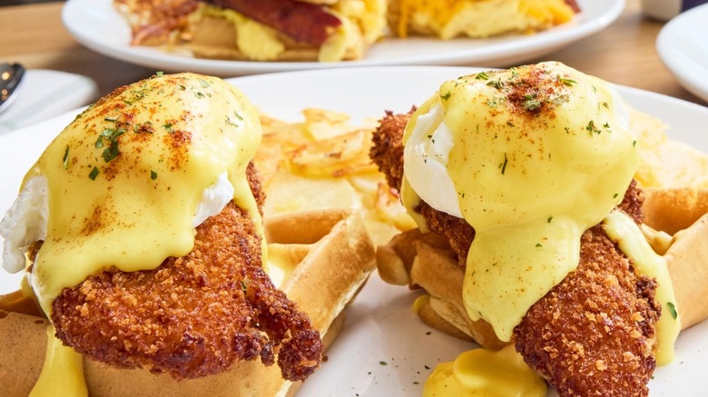 Eggs Benedict over fried chicken and waffles