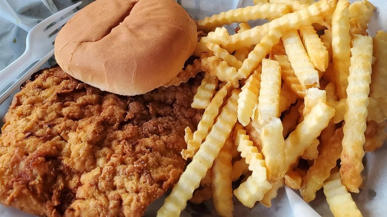Breaded pork tenderloin sandwich with fries