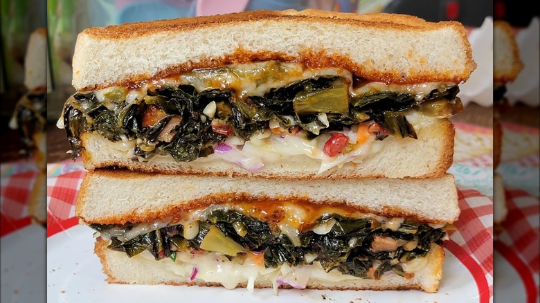 Two stacked halves of a collard sandwich
