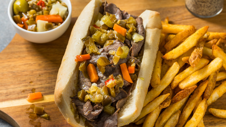 Italian beef sandwich with fries and side of pickled veg