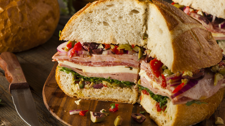 Muffuletta with section missing to show inside the sandwich