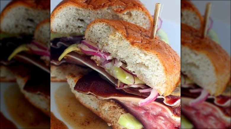Halves of a pig ear sandwich with slaw