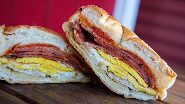 Halves of a Taylor ham pork roll breakfast sandwich with egg