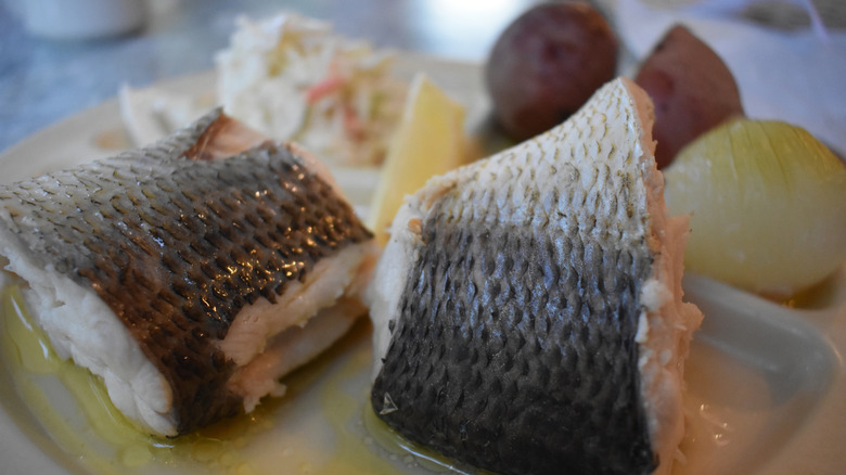 Close-up of boiled white fish, onion, potatoes, and coleslaw from Door County fish boil