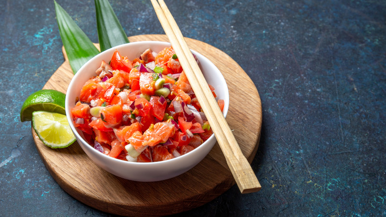 Lomi lomi salmon served in white bowl with chopsticks