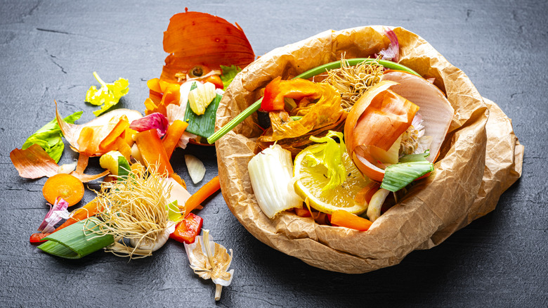 Assorted kitchen waste paper bag with fruit and vegetable peels inside