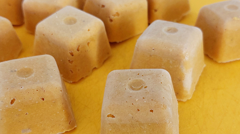 Frozen soup cubes yellow background