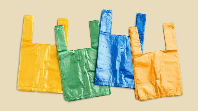 Differently colored plastic grocery bags in row