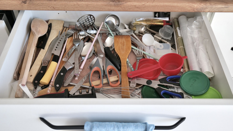 Open drawer showing cluttered kitchen utensils