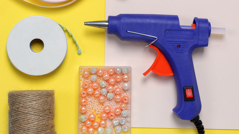 DIY crafting materials, including a glue gun and jute